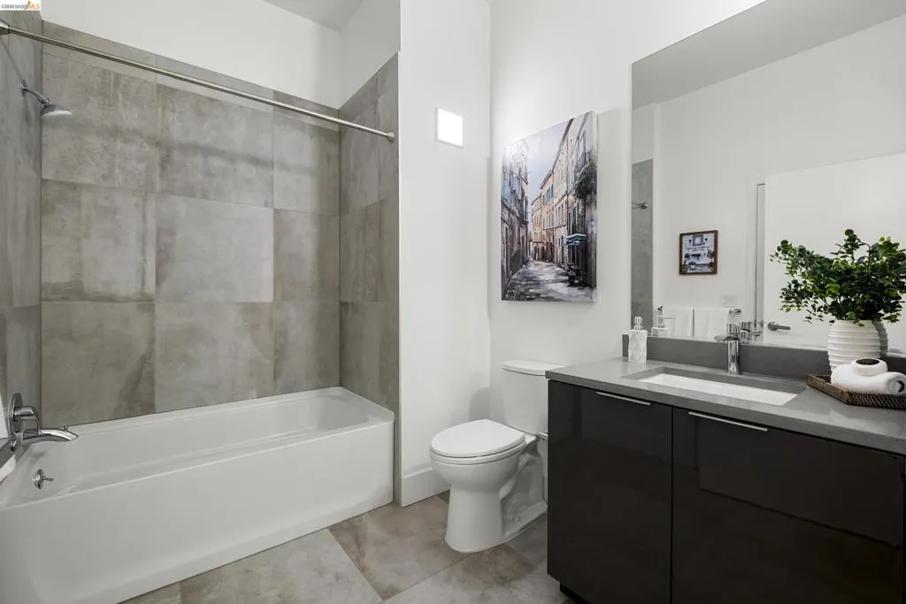 Full bath featuring bathtub / shower combination, vanity, and light tile patterned flooring