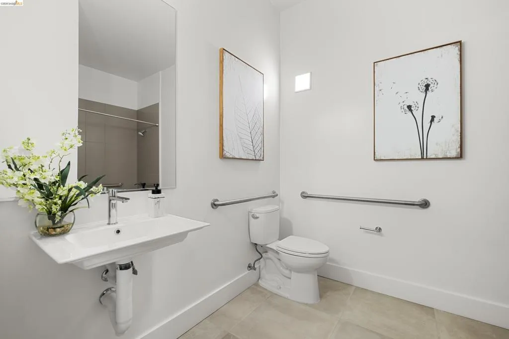 Bathroom with light tile patterned flooring and a shower