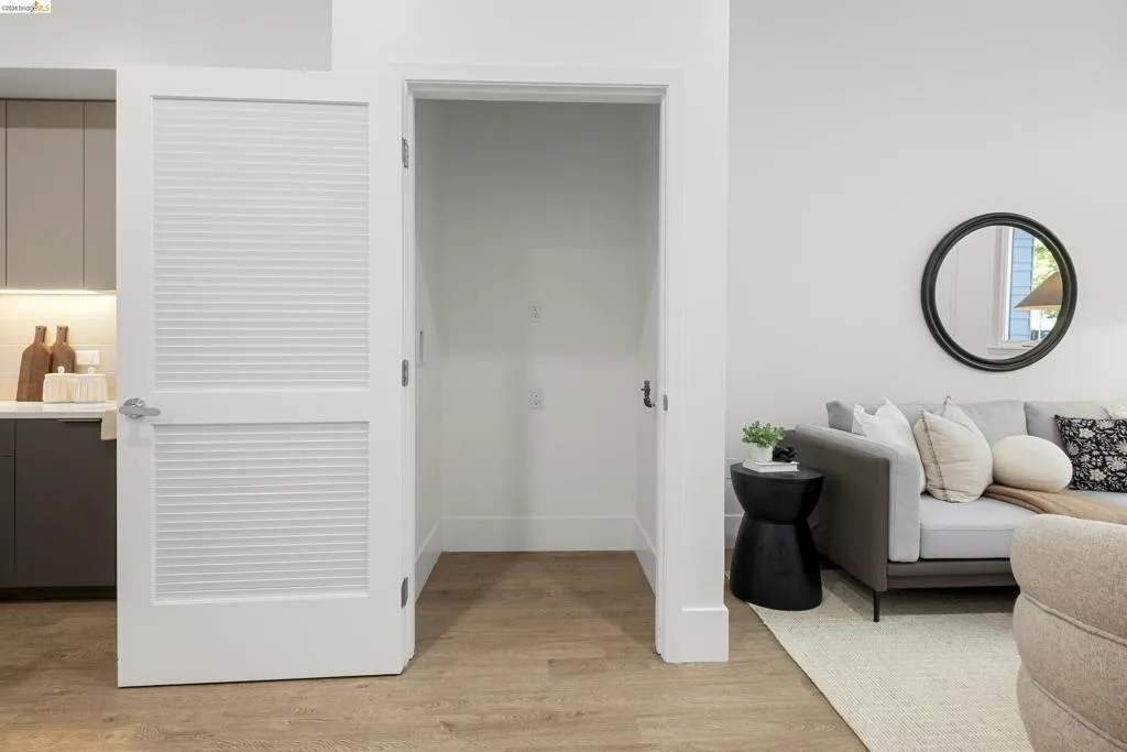 Living room with light wood-type flooring and baseboards