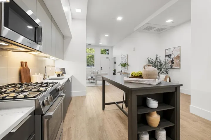 Kitchen featuring appliances with stainless steel finishes, light wood-style floors, tasteful backsplash, recessed lighting, and modern cabinets