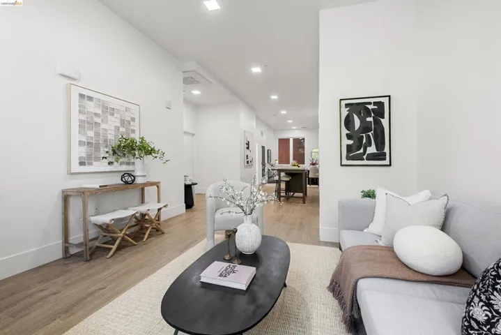 Living area featuring light wood finished floors and recessed lighting