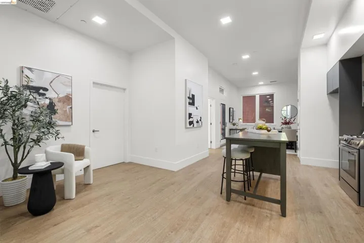 Dining room with light wood-style flooring and recessed lighting