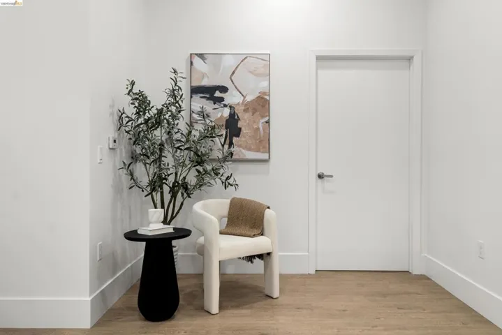 Living area featuring light wood-style floors and baseboards