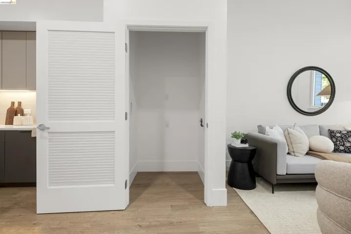 Living room with light wood-type flooring and baseboards