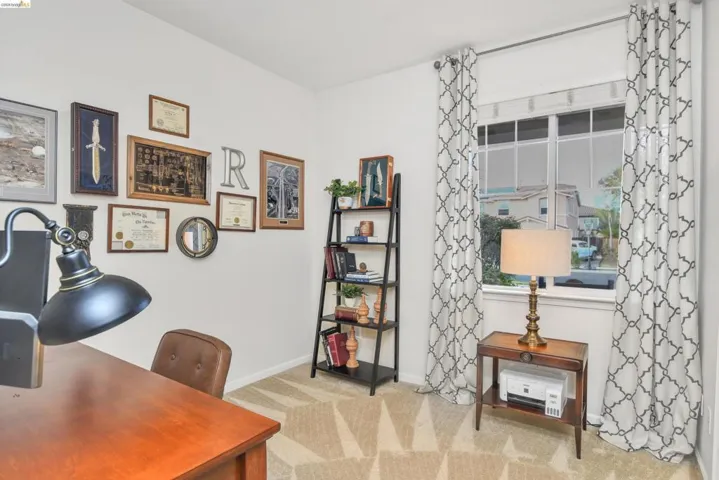 Office area with light colored carpet and baseboards