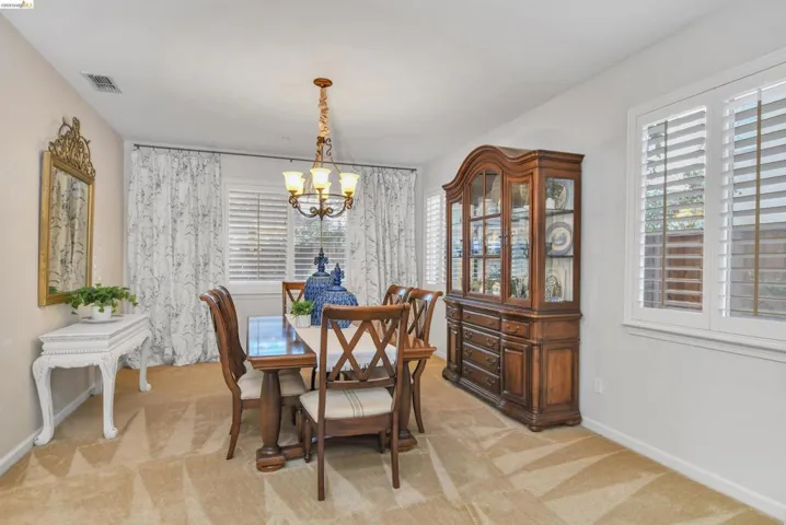 Dining area featuring a chandelier and light carpet