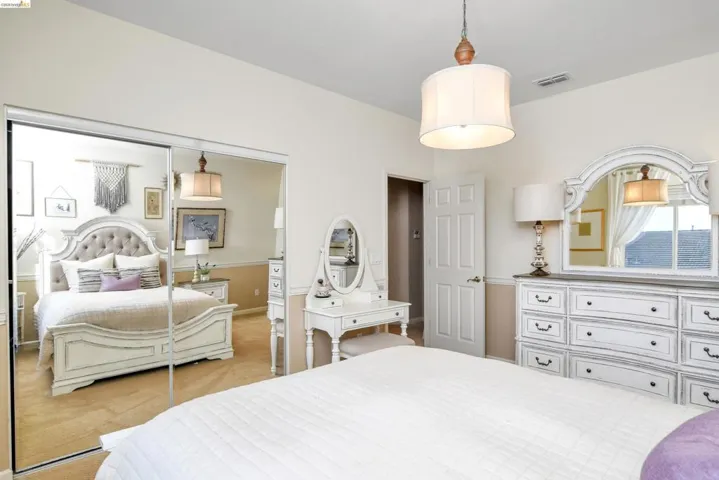 Bedroom featuring light colored carpet and a closet