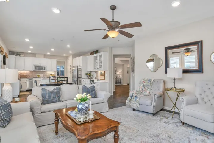 Living room with recessed lighting, a ceiling fan, and healthy amount of natural light