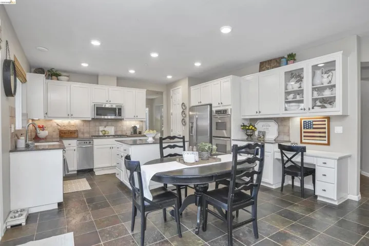 Dining area featuring recessed lighting, an office area, and dark stone finish floors