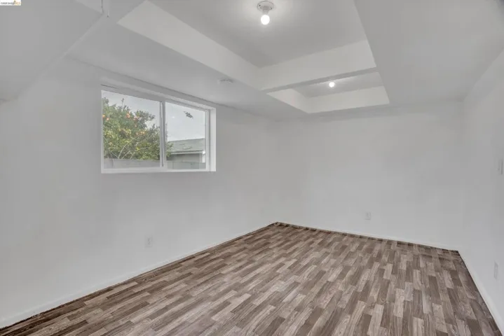 Bonus room with light wood finished floors and baseboards