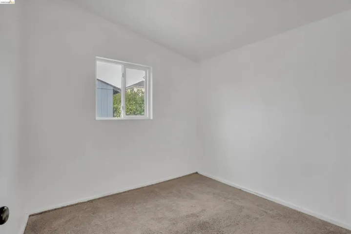 Unfurnished room featuring carpet and baseboards