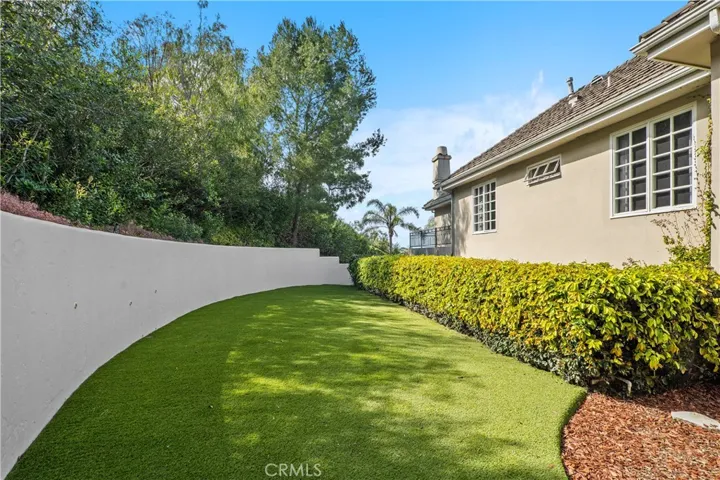 Newly turfed side area right off the bonus room that wraps to the back yard!