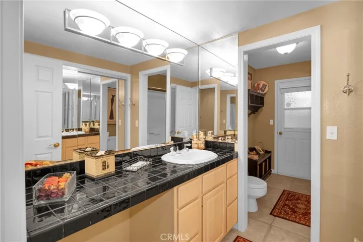 Main floor bed ensuite bath with walk-in shower and private entry
