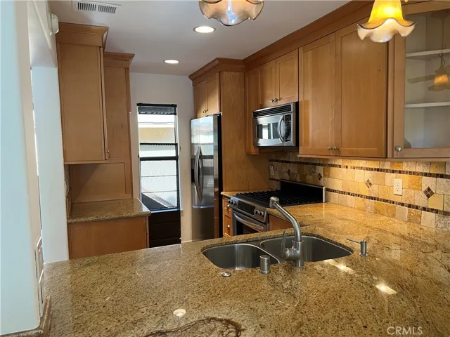 remodeled kitchen with granite counters and stainless steel appliances