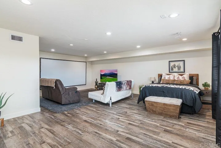 Lower level versatile bedroom space easily doubles as media or rec room