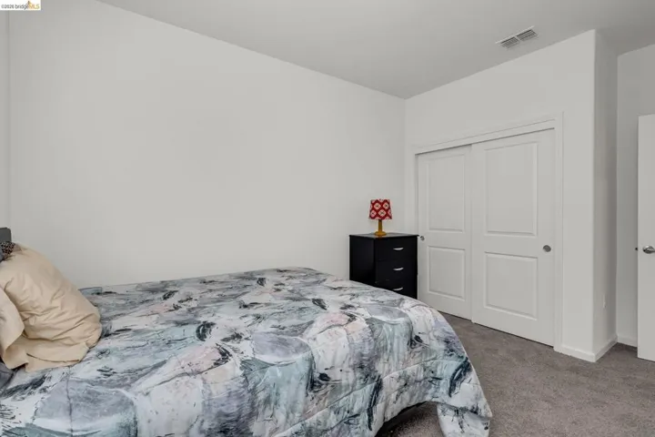 Bedroom featuring dark carpet and a closet