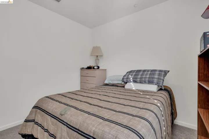 Carpeted bedroom featuring baseboards