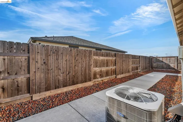 Fenced backyard with a patio