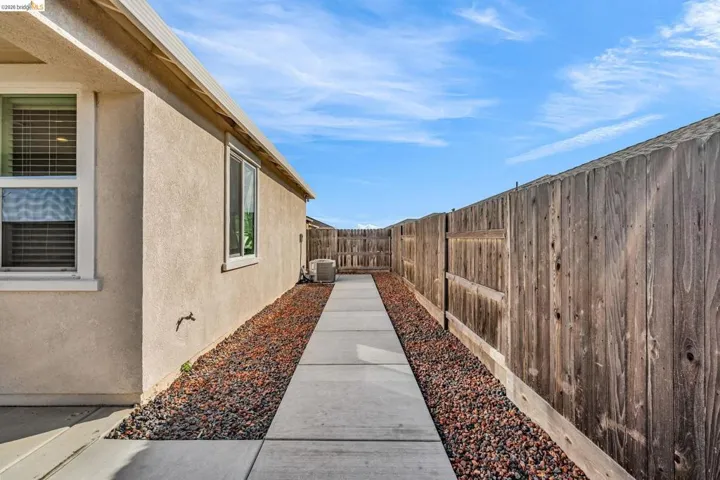 View of home's exterior with stucco siding and a fenced backyard