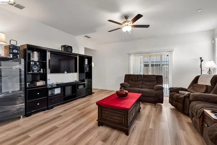 Living room featuring light wood-style flooring and ceiling fan