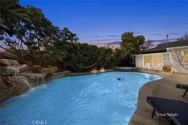 Resort-Style Backyard
Lush landscaping, sparkling pool with rock waterfall, spa, and fenced safety area—perfect for relaxing or entertaining.