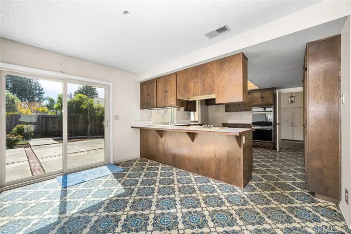 Eat-in kitchen with direct access to backyard.