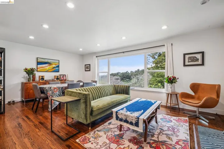Living room with dark wood-style flooring and recessed lighting