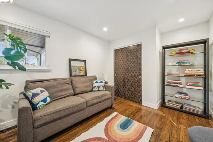 Living area featuring dark wood finished floors and recessed lighting