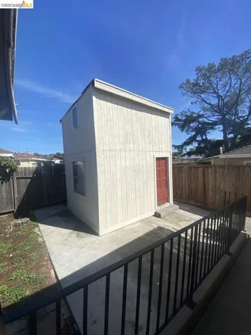 View of outdoor structure featuring a fenced backyard