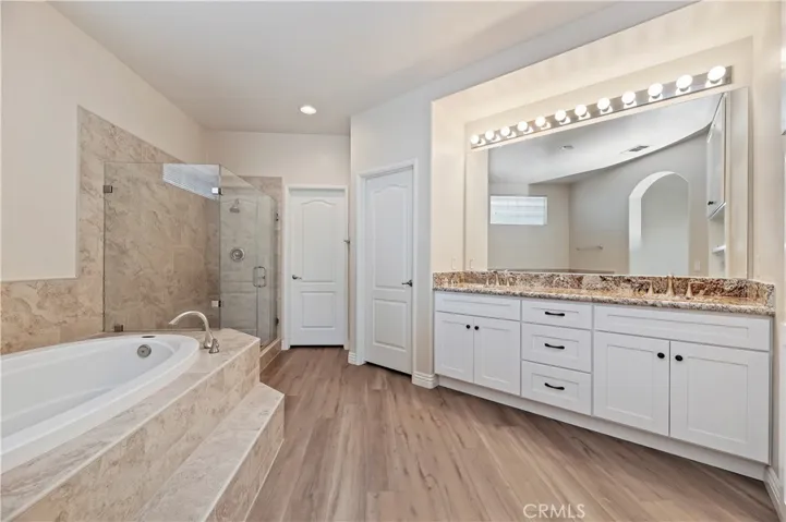 Your primary bath has new tile in the shower and tub area, rimless shower doors, new cabinets and new fixtures.