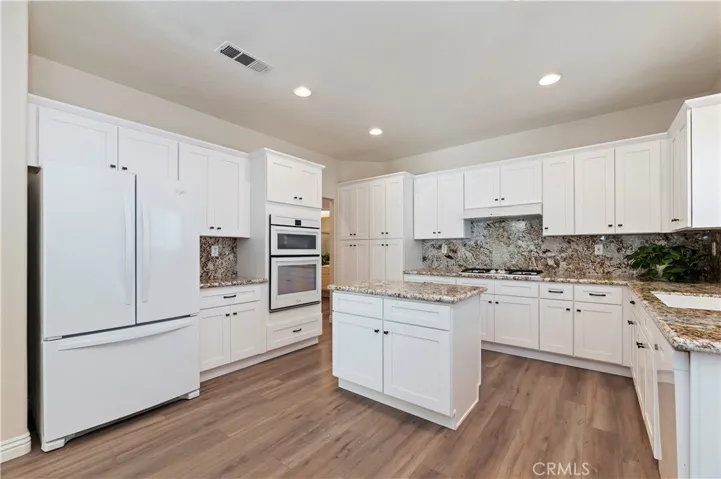 Your kitchen has new white cabinets, stunning granite and a convenient center island giving you lots of storage and counter top space.