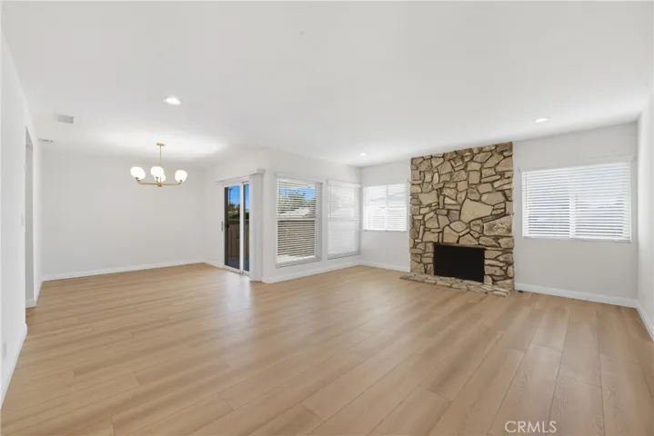 Photo of the living room with the gas wood burning stone fireplace