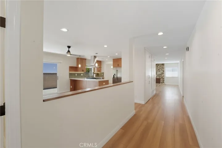 Photo of foyer to hallway with view of the beautiful kitchen.