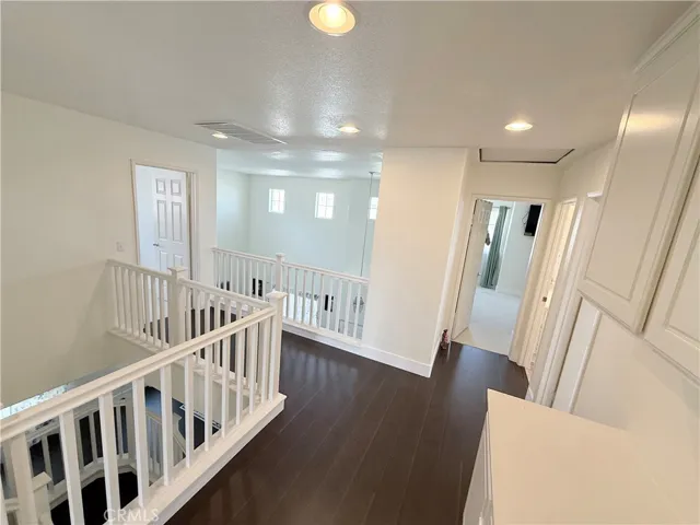 recess lighting, with hardwood flooring showcased throughout the upstairs...