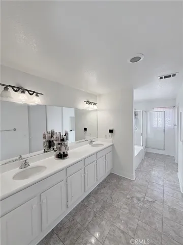 his and her sinks, tile flooring and recess lighting at primary​​‌​​​​‌​​‌‌​​‌​​​‌‌​​​‌​​‌‌​​‌‌​​‌‌​​​​ bathroom