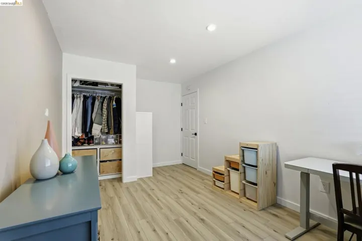 Home office featuring light wood-style floors and recessed lighting