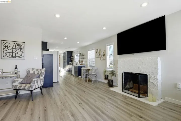 Living area featuring recessed lighting, light wood-style floors, and a fireplace