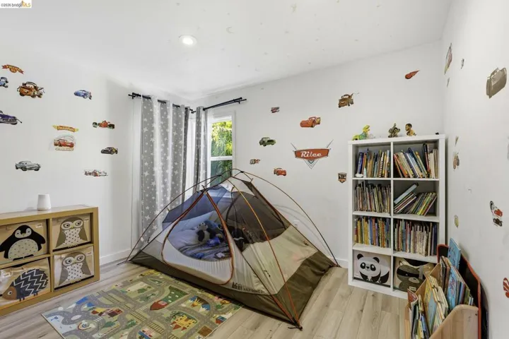 Bedroom featuring light wood-style floors and baseboards