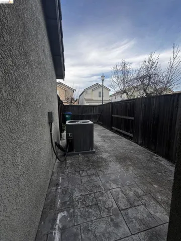 Fenced backyard with a patio