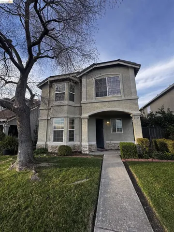 View of front of property featuring stucco siding, stone siding, and a porch