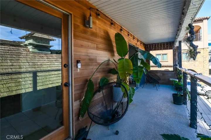 Unit #64 - Front entry has a custom glass door entry and decorative wood side paneling.