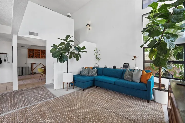 Unit #64 - Living room, stairwell and entry to the kitchen.