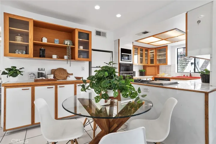 Unit #66 - Built in buffet and kitchen eating area is functional and convenient.