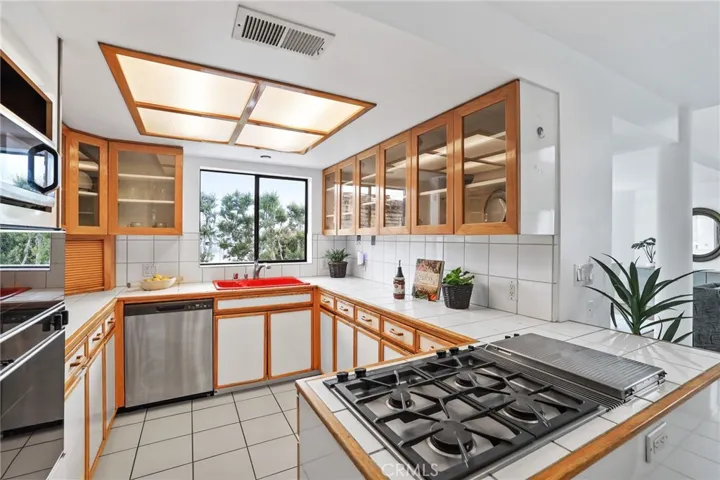 Unit #66 - Gas stove top w/griddle, oven, microwave and dishwasher.