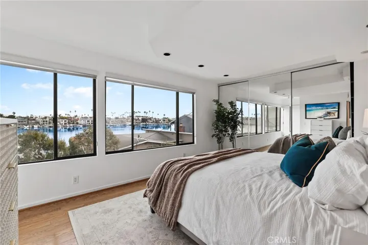 Unit #66 - Primay suite has panoramic view of Alamitos Bay and mirrored wall-length closet doors.