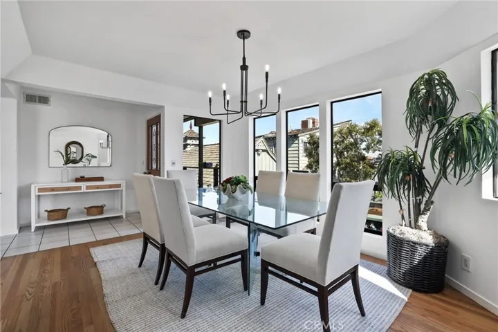 Unit #66 - The Dining room has a beautiful view of Alamitos Bay from the full length windows.