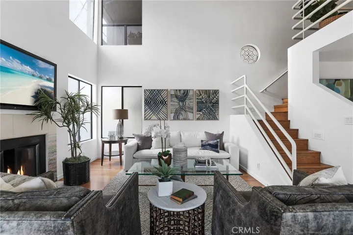 Unit #66 - Living room has a dramatic two story ceiling with windows that span the height to give lots of natural light