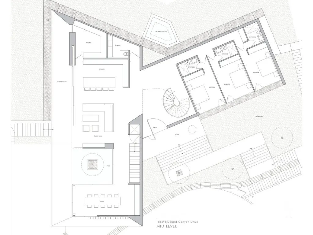 The main living level is designed for both everyday living and elevated entertaining, featuring an open-concept kitchen, dining, and family room that seamlessly connect to outdoor spaces. A central courtyard element introduces natural light and a calming focal point, while the bedroom wing offers privacy and separation. The layout creates a balanced flow between social and private spaces, all oriented to maximize light, air, and the surrounding coastal setting.