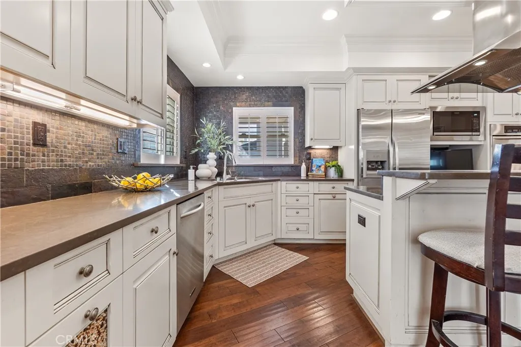 Bright and spacious kitchen with abundant cabinetry, hardwood floors, and quality finishes.