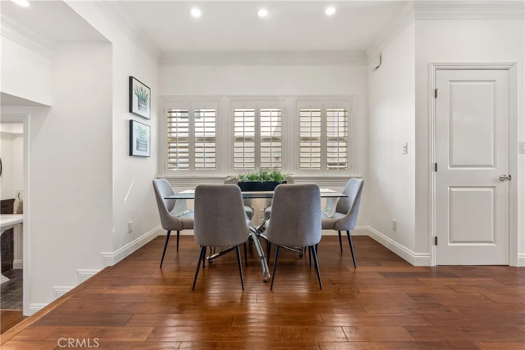 Inviting dining area with rich hardwood floors, abundant natural light, and an open connection to the main living areas.